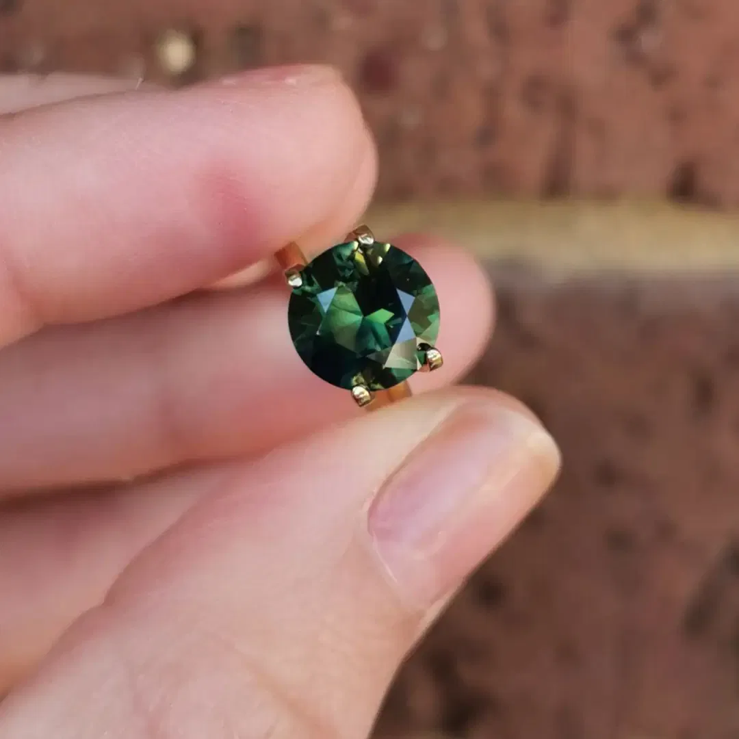 a close up of the emerald and diamond ring